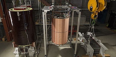 The structure demonstrates the individual components (left to right): primary coil with transformer iron coil, secondary coil on the new coil body and iron core joke to fix the other components.