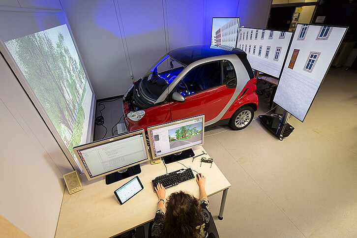 Around the vehicle, the three-dimensional, artificial world is presented on a screen or a monitor. Looking out of the window or the rear-vision mirror, the driver thus obtains an unobstructed view of the virtually natural driving environment. (Picture: Patrick Langer/KIT)