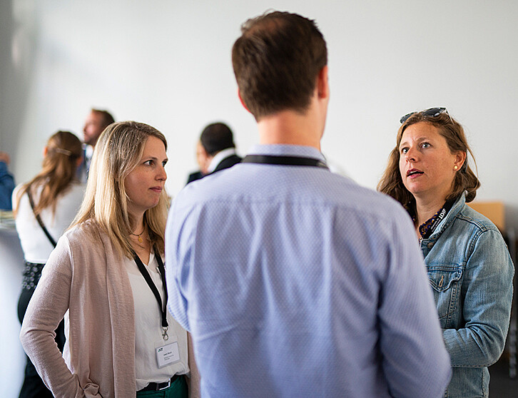 Laura Bosch und Agnes Honka im Gespräch mit einem Mitglied der KIT Industry Expert. Beide haben das Konzept für das industrienahe Netzwerk am KIT gemeinsam erarbeitet. (Bild: Robert Fuge / KIT)